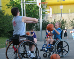 Danielle plays catch with young wheelchair athlete